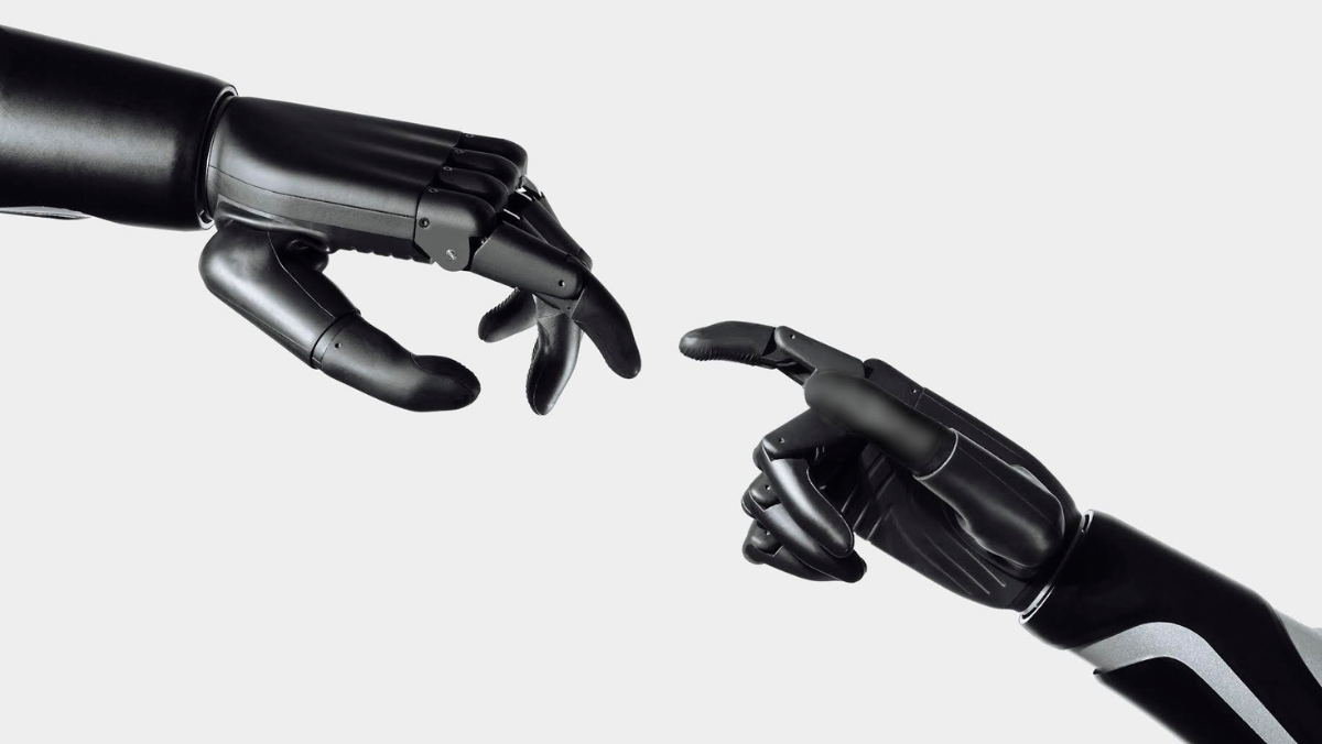 Two robotic prosthetic hands reaching toward each other against a white background.